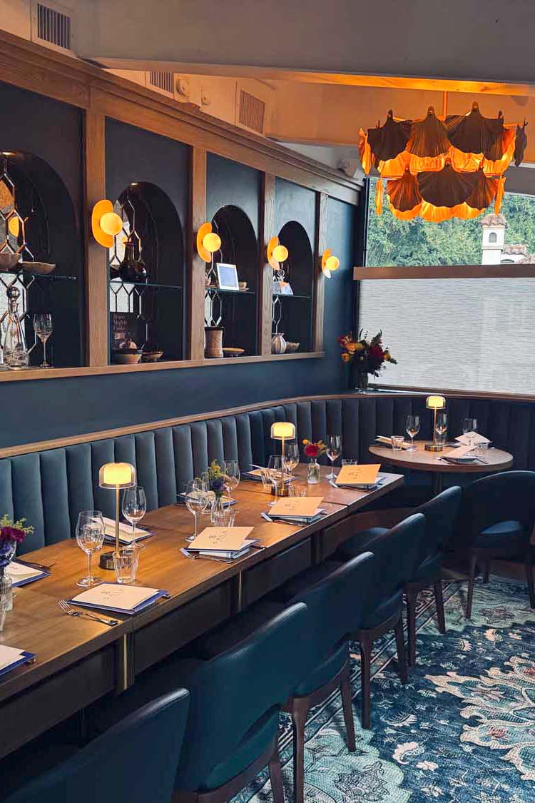 a long restaurant table with blue chairs